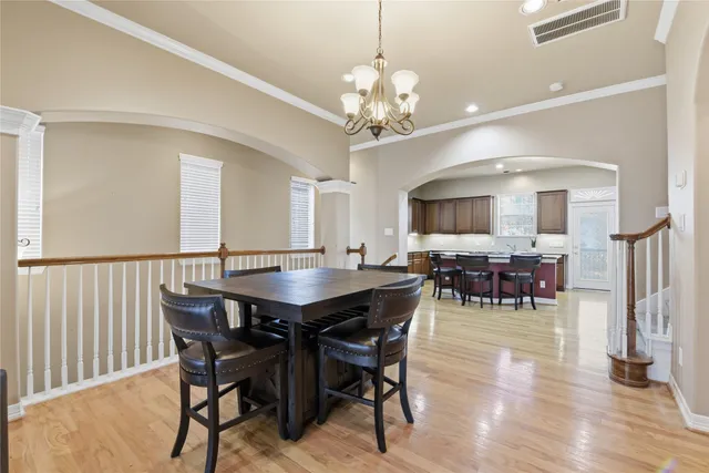 a view of a dining room with furniture and chandelier