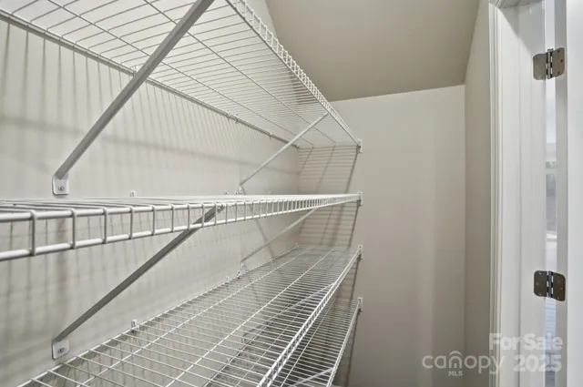 a large white kitchen with kitchen island a sink a center island and wooden floor