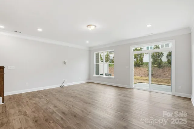 a view of a kitchen with wooden floor and a sink