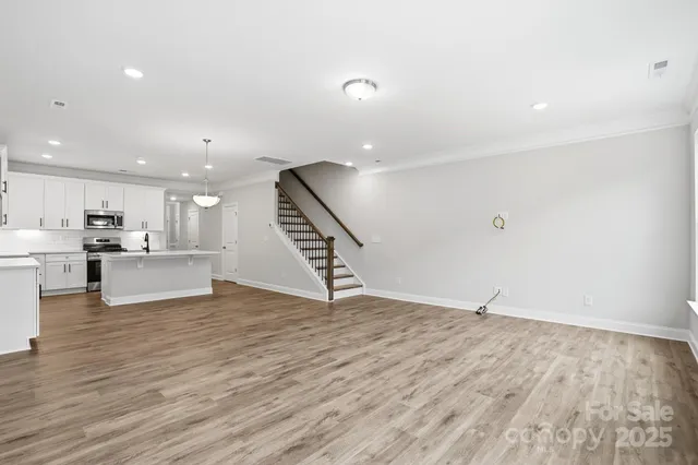 a view of kitchen and hall with wooden floor