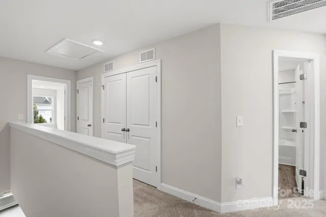 an empty room with windows and closet