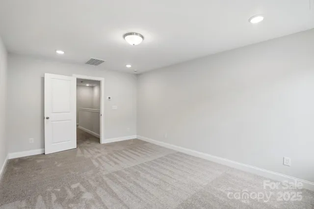 an empty room with a fireplace and cabinet