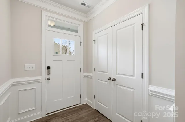 an entryway view with wooden floor