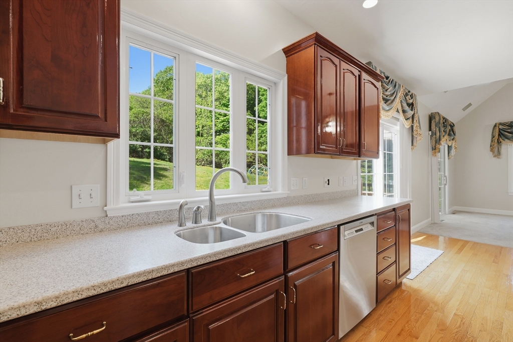 61 Indian Head Road Framingham, MA 01701 - Photo 10 of 42 a kitchen with a sink and wooden cabinets
