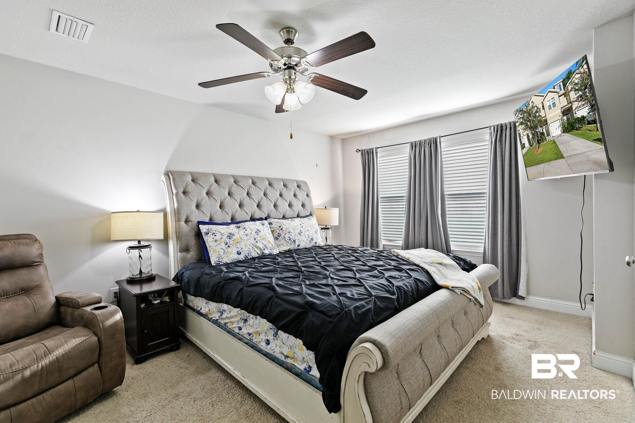 25806 Pollard Road, Unit 24 Daphne, AL 36526 - Photo 17 of 33 Bedroom with light carpet and a ceiling fan