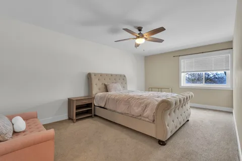 a bedroom with a bed and a couch