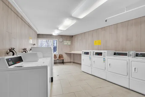 a living room with fireplace furniture and a large window