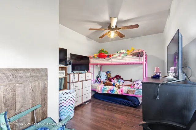 a bed room with furniture and wooden floor