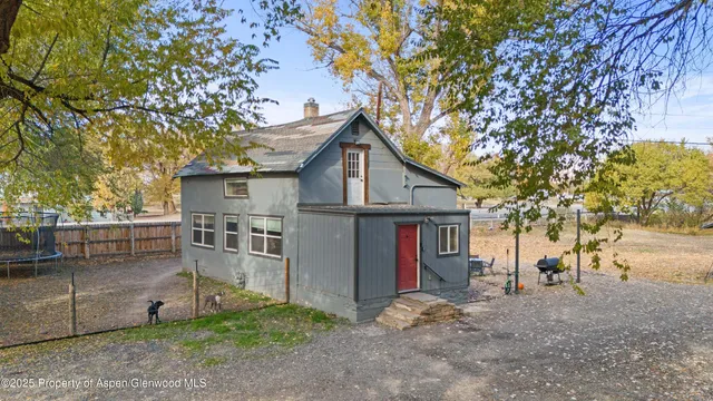 a view of a house with a yard and tree s