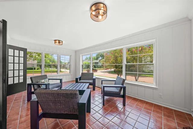 a dining room with furniture and a window