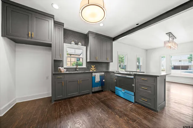 a kitchen with sink cabinets and wooden floor