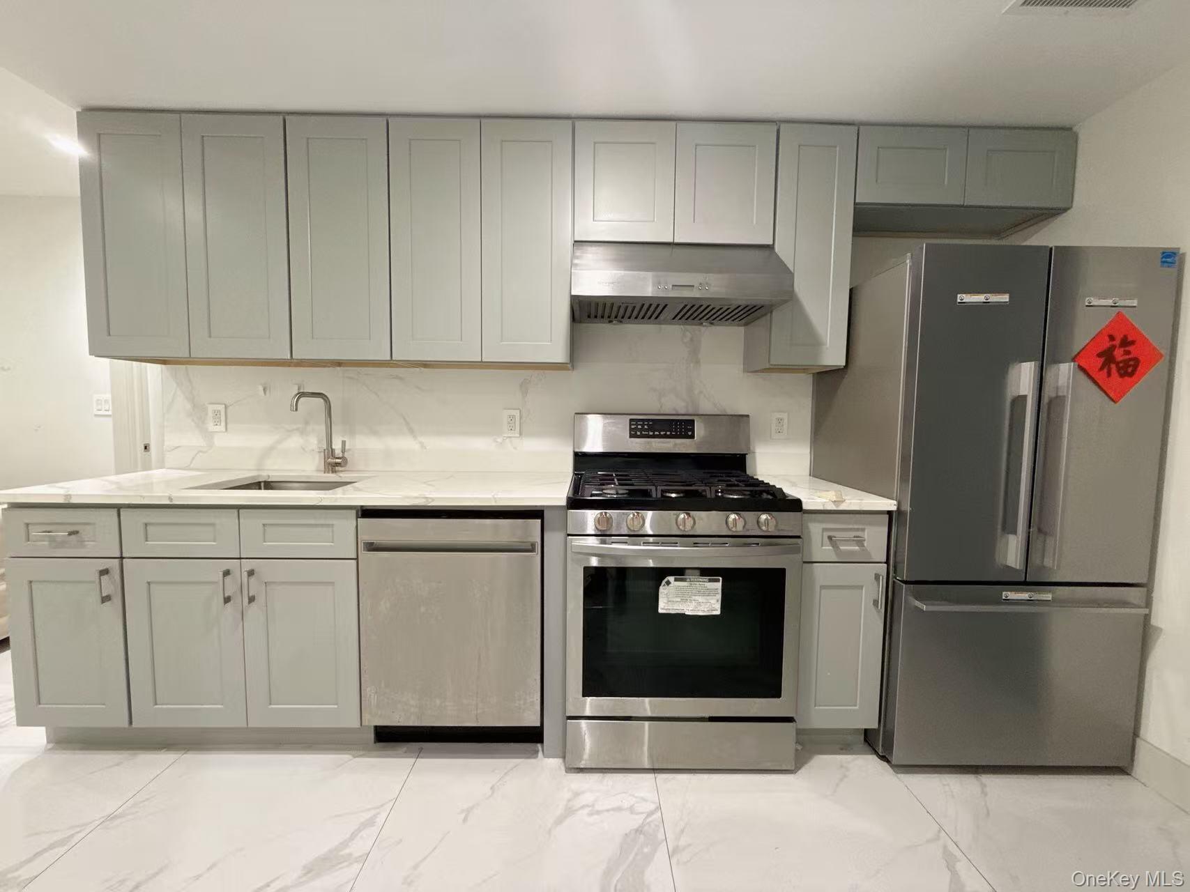 41-62 Bowne Street, Unit 3E Queens, NY 11355 - Photo 3 of 9 a kitchen with stainless steel appliances granite countertop a stove a refrigerator and a sink