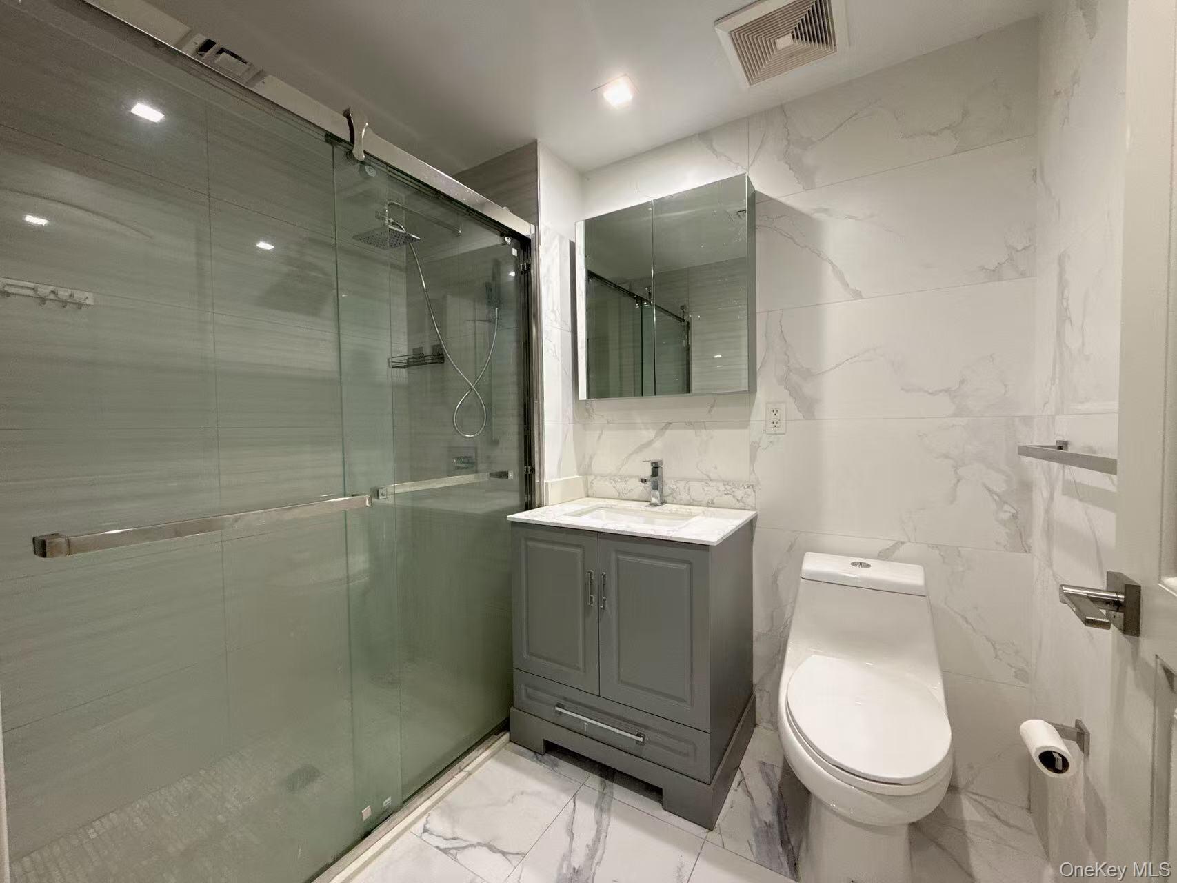 41-62 Bowne Street, Unit 3E Queens, NY 11355 - Photo 8 of 9 a bathroom with a sink toilet and shower