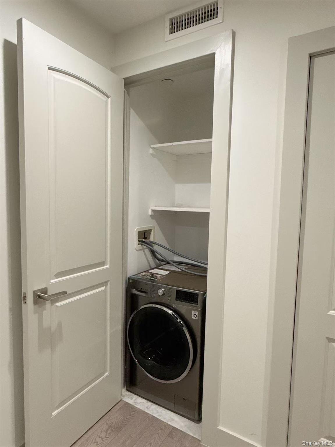 41-62 Bowne Street, Unit 3E Queens, NY 11355 - Photo 9 of 9 a utility room with washing machine