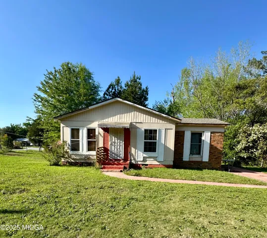 a front view of house with yard and green space
