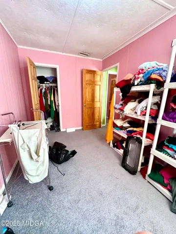 a bedroom with bed and a closet