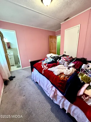 a bed sitting in a bedroom next to a window