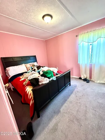 a bed sitting in a bedroom next to a window