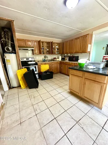 a kitchen with stainless steel appliances kitchen island granite countertop a sink and cabinets