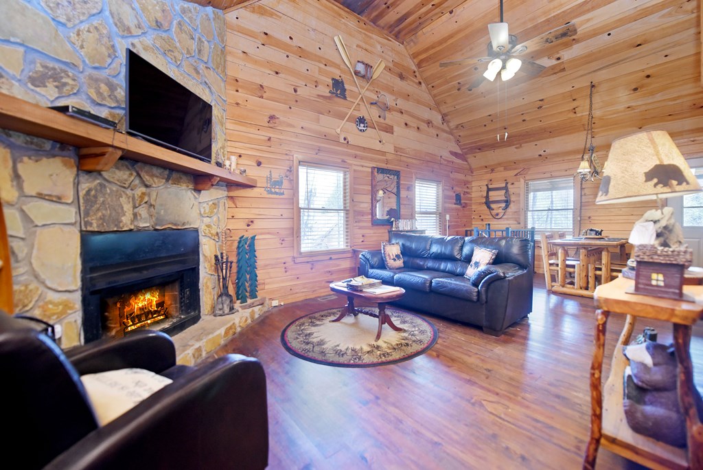 545 Laurel Circle Blue Ridge, GA 30513 - Photo 24 of 54 a living room with furniture a fireplace and a large window