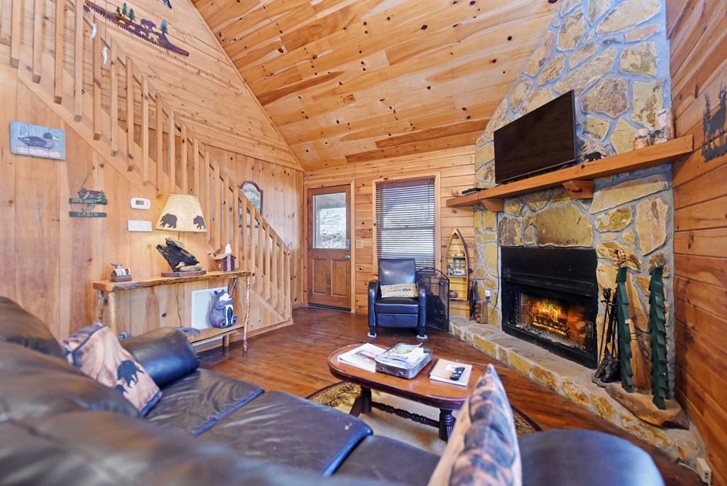 545 Laurel Circle Blue Ridge, GA 30513 - Photo 26 of 54 a living room with furniture a flat screen tv and a fireplace