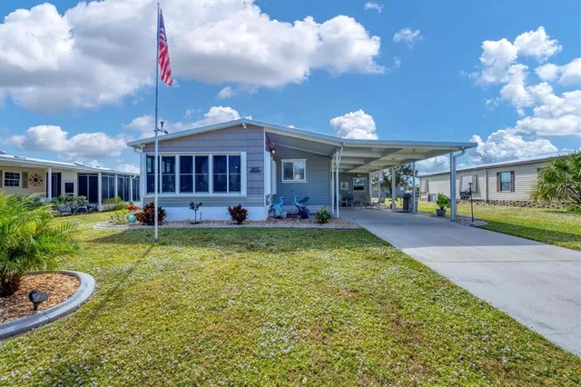 a view of a house with a backyard porch and sitting area