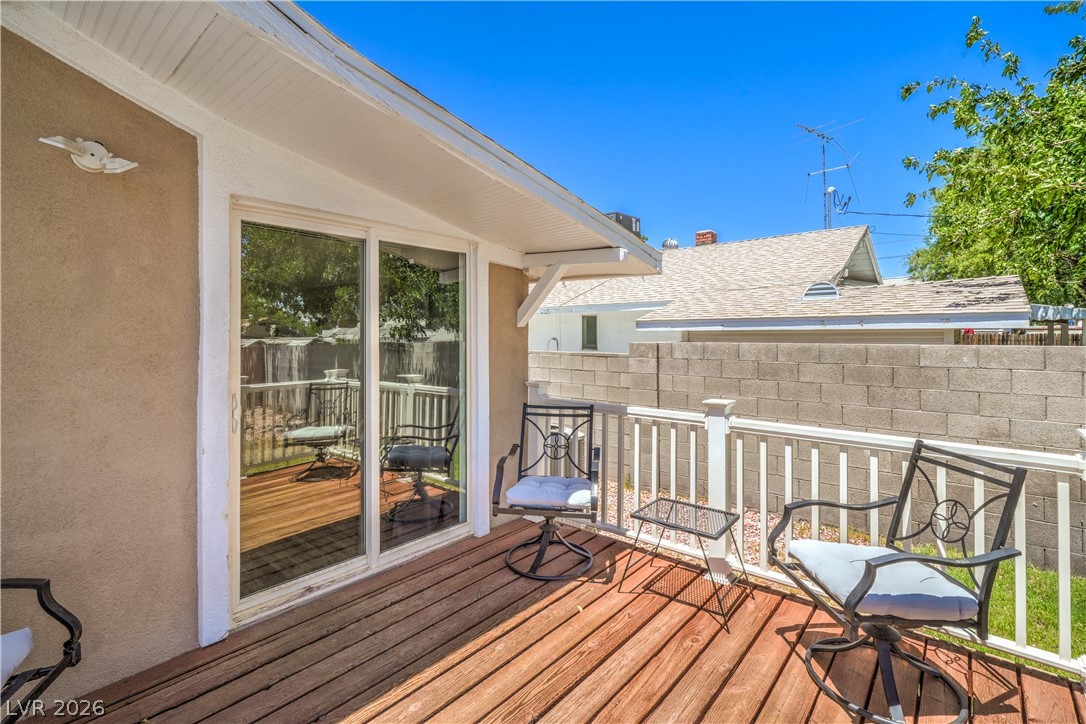 623 California Avenue Boulder City, NV 89005 - Photo 33 of 38 Backyard with Deck, Patio, and Mature Landscaping including Palm Trees, and Front and Rear Lawn