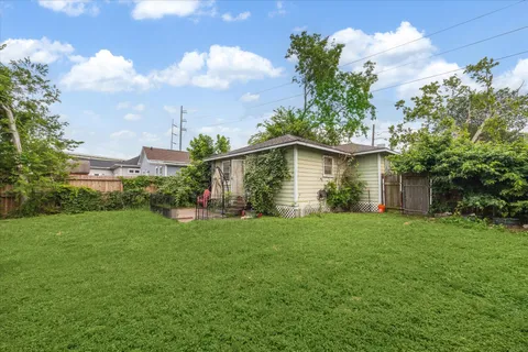 a view of a house with a yard and garden