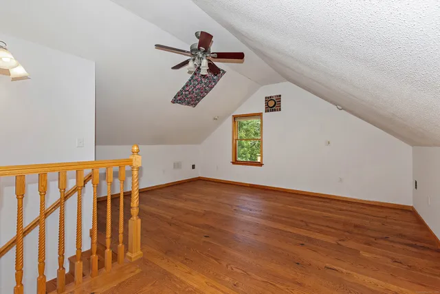 a view of an empty room with a fireplace