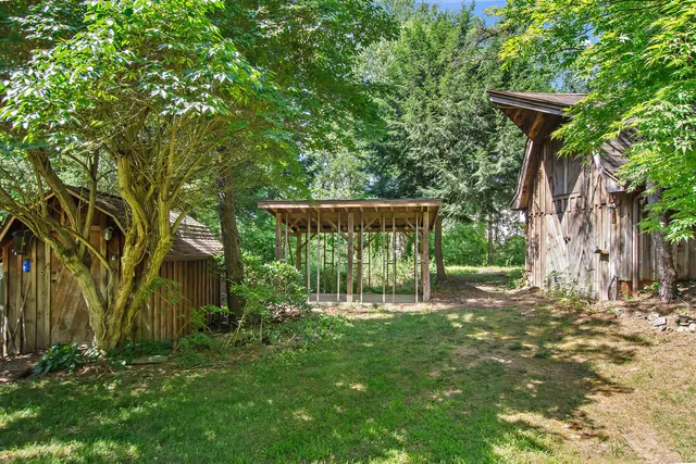 a garden with trees in front of it