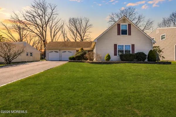 a view of house with backyard