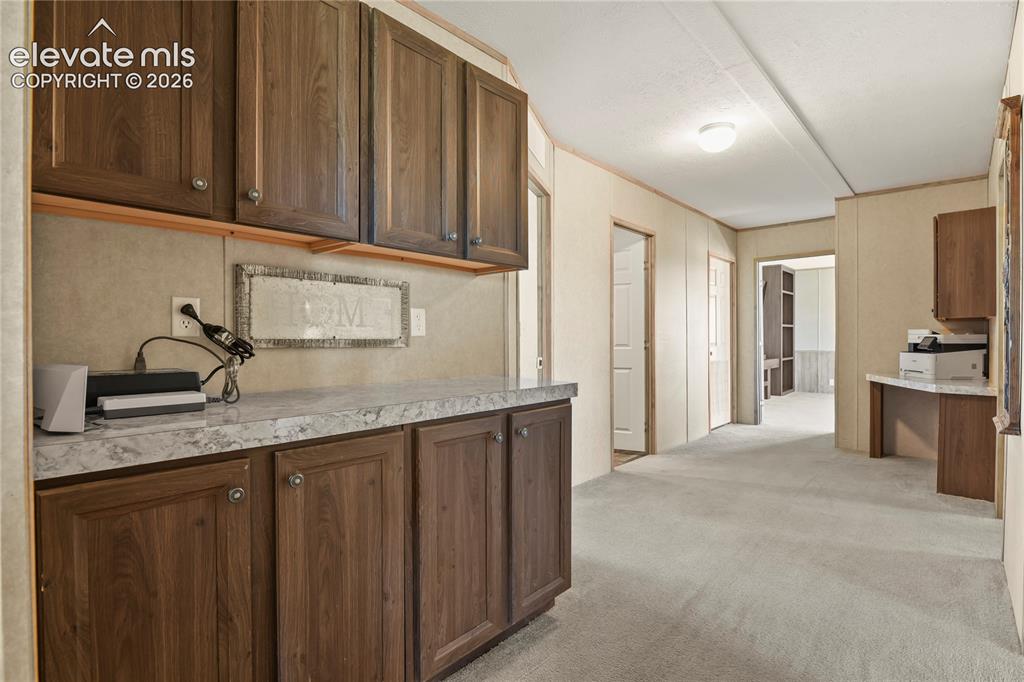 22280 Jones Road Peyton, CO 80831 - Photo 21 of 47 a kitchen with granite countertop stainless steel appliances a sink refrigerator and cabinets