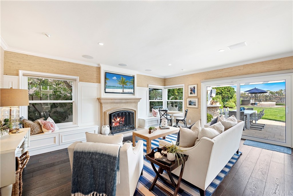 28 Bethany Laguna Niguel, CA 92677 - Photo 18 of 50 Gather or relax in the family room with cozy fireplace & sliding door entry leading to the impressive backyard.