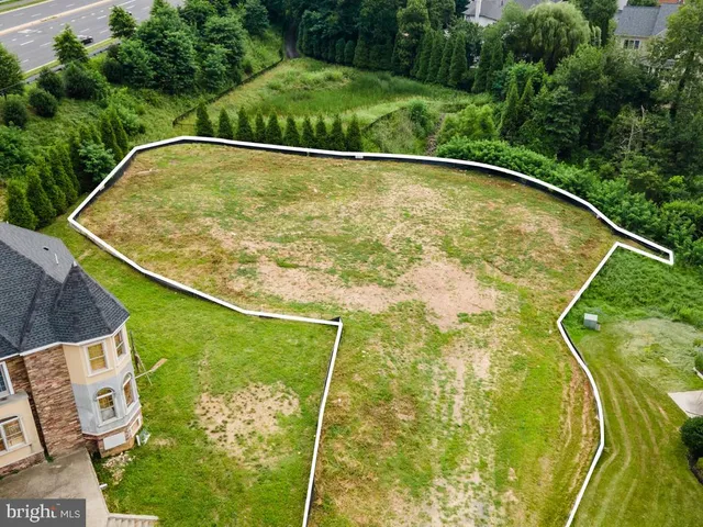 a view of a swimming pool with a yard and seating area
