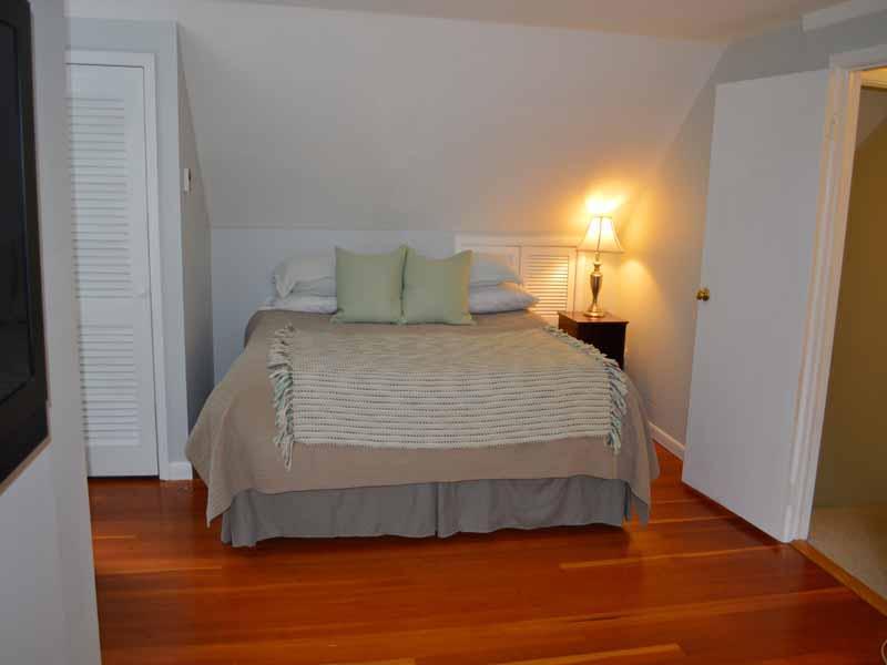 34 Meeker Court Rowayton, CT 06853 - Photo 14 of 22 a bedroom with a bed and wooden floor