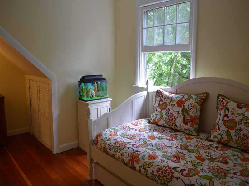 34 Meeker Court Rowayton, CT 06853 - Photo 19 of 22 a bed sitting in a bedroom next to a window