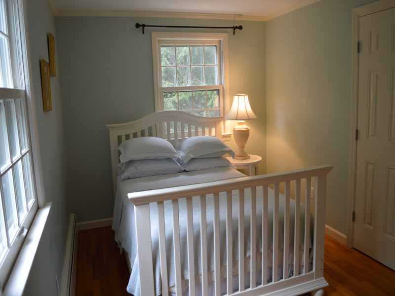34 Meeker Court Rowayton, CT 06853 - Photo 20 of 22 a bedroom with a bed and wooden floor