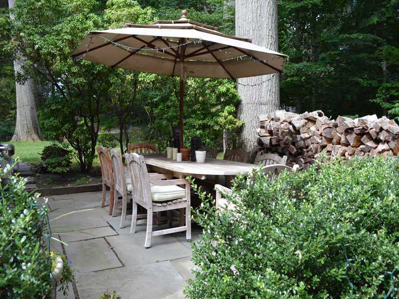 34 Meeker Court Rowayton, CT 06853 - Photo 21 of 22 a view of a patio with furniture and table under an umbrella