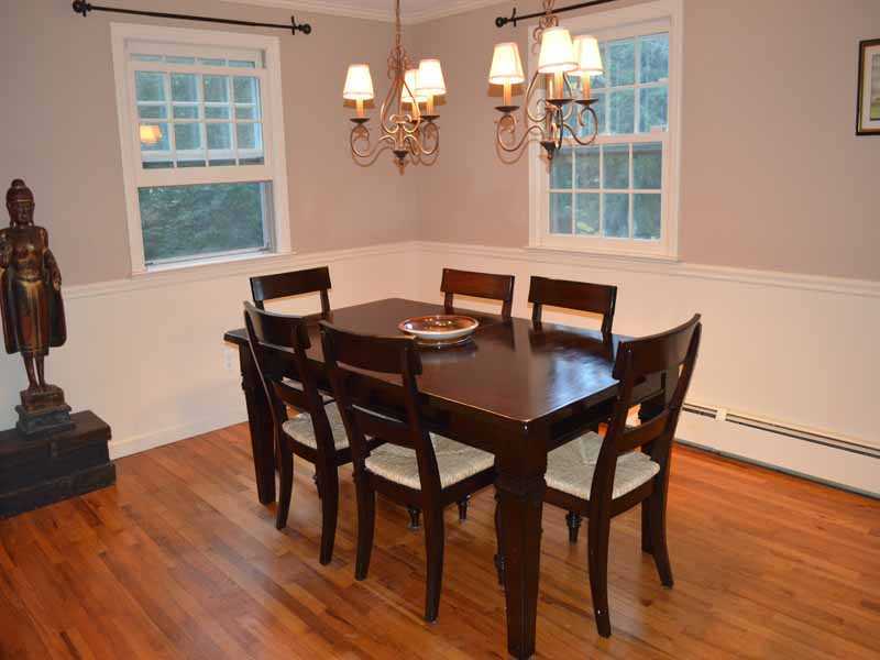 34 Meeker Court Rowayton, CT 06853 - Photo 8 of 22 a view of a dining room with furniture wooden floor and a chandelier