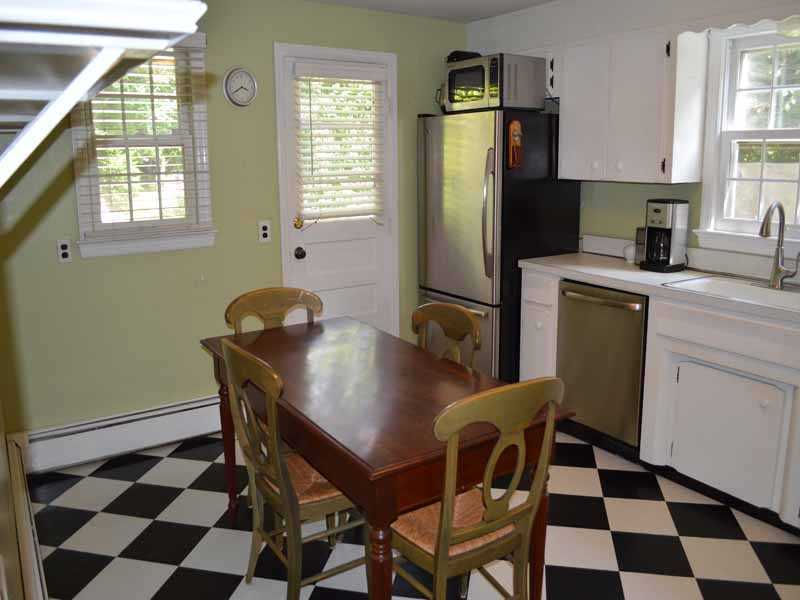 34 Meeker Court Rowayton, CT 06853 - Photo 10 of 22 a kitchen with a refrigerator a table and chairs