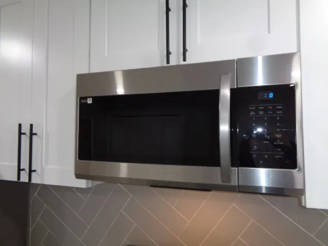 a bathroom with a shower and mirror