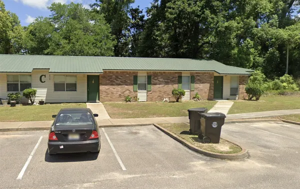 a view of a patio with table and chairs potted plants