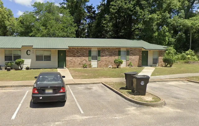 a view of a patio with table and chairs potted plants