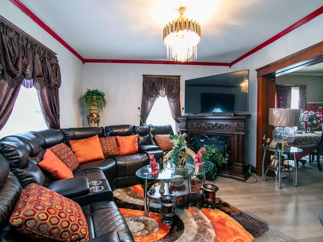 a living room with furniture a flat screen tv and a fireplace