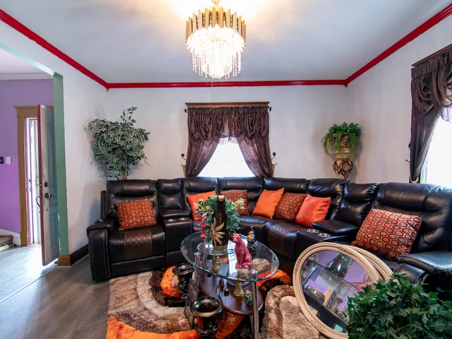 a living room with furniture and a potted plant