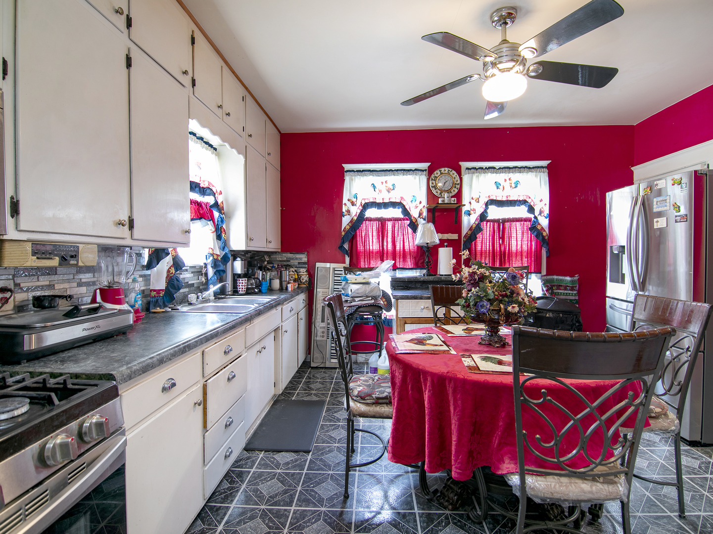 971 North Cleveland Avenue Kankakee, IL 60901 - Photo 8 of 19 a kitchen with stainless steel appliances kitchen island granite countertop a stove a sink dishwasher and a dining table with chairs