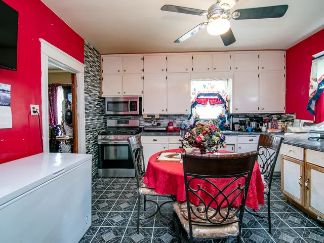 a kitchen with stainless steel appliances kitchen island granite countertop a stove top oven a sink and dishwasher