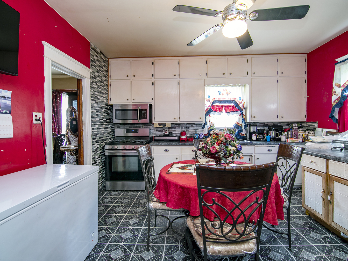 971 North Cleveland Avenue Kankakee, IL 60901 - Photo 9 of 19 a kitchen with stainless steel appliances kitchen island granite countertop a stove top oven a sink and dishwasher