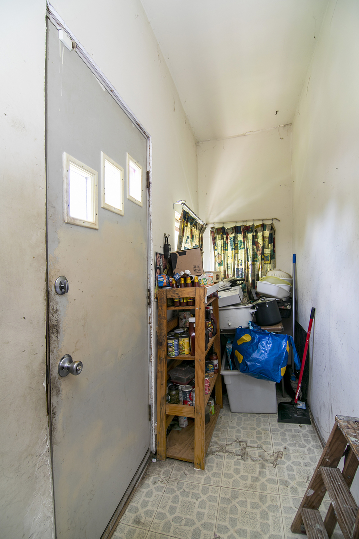 971 North Cleveland Avenue Kankakee, IL 60901 - Photo 10 of 19 a living room with furniture and a book shelf