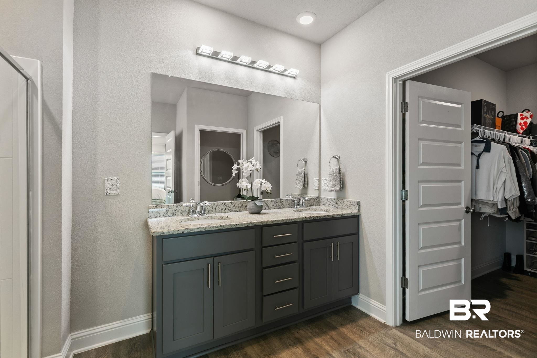 31650 Memphis Loop Daphne, AL 36527 - Photo 25 of 68 Full bath featuring double vanity, dark wood-style floors, a walk in closet, a textured wall, and recessed lighting